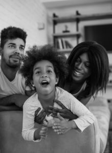 Happy black family playing with their kid Denver Colorado luxury real estate