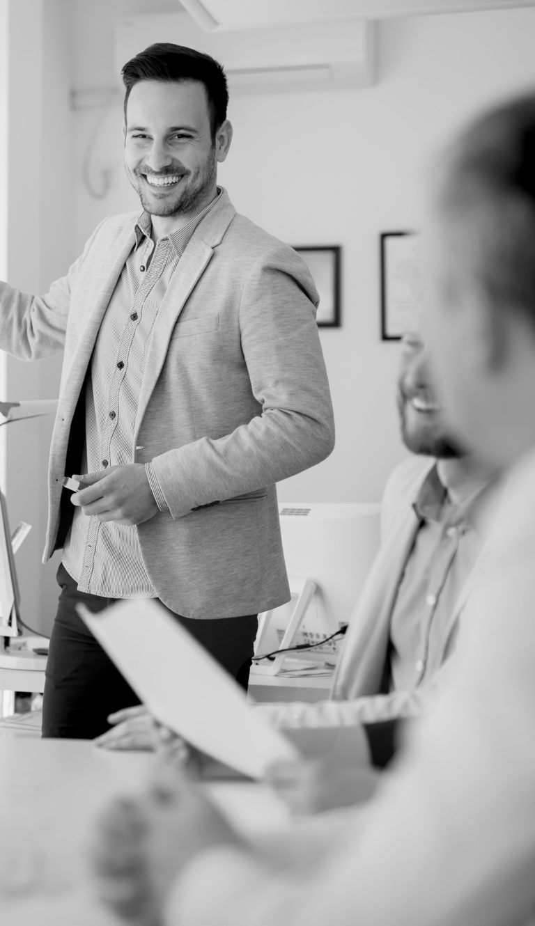 A real Estate agent presenting to a group of professionals