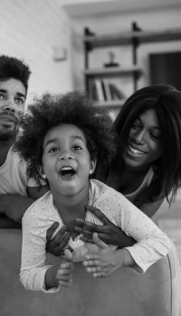 Portrait of happy black family having fun playing at home.